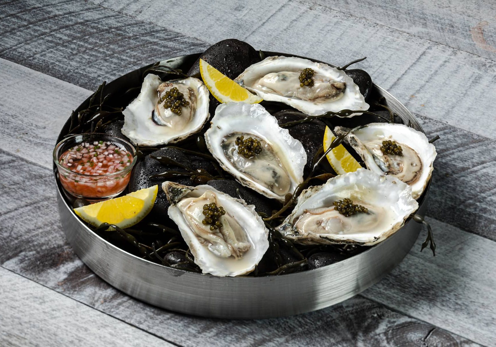 Platter of oysters on the half shell topped with caviar